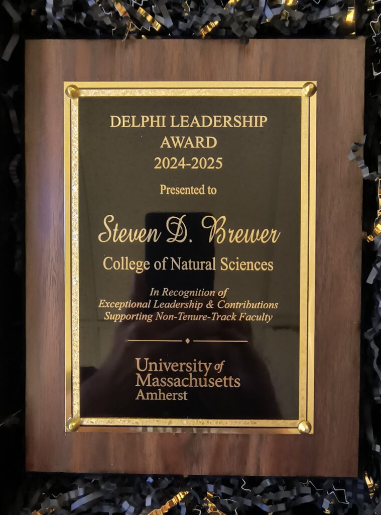 Plaque that reads, "DELPHI LEADERSHIP AWARD 2024-2025 Presented to Steven D. Brewer; College of Natural Sciences; In Recognition of Exceptional Leadership & Contributions Supporting Non-Tenure-Track Faculty; University of Massachusetts Amherst