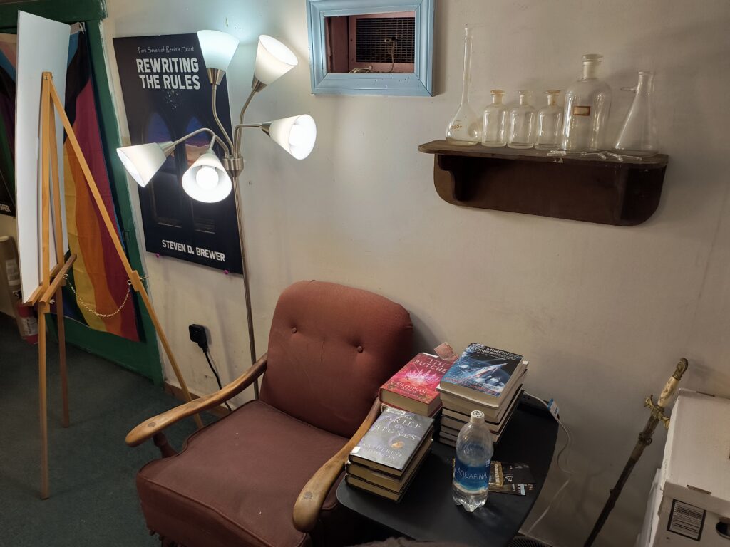 Reading nook with an old chair, floor lamp, and large TBR