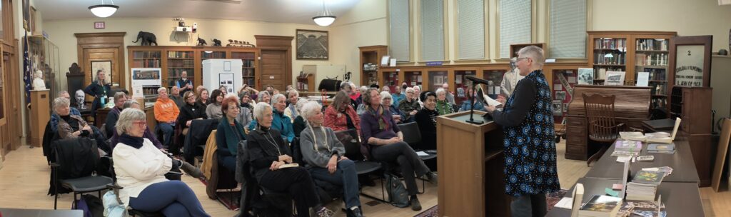 LJ Cohen reads in front of a sizeable audience