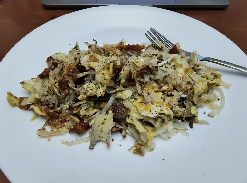 Maggot's Breakfast Spew: a plate of hashbrowns with scrambled eggs, sausage, and bacon.