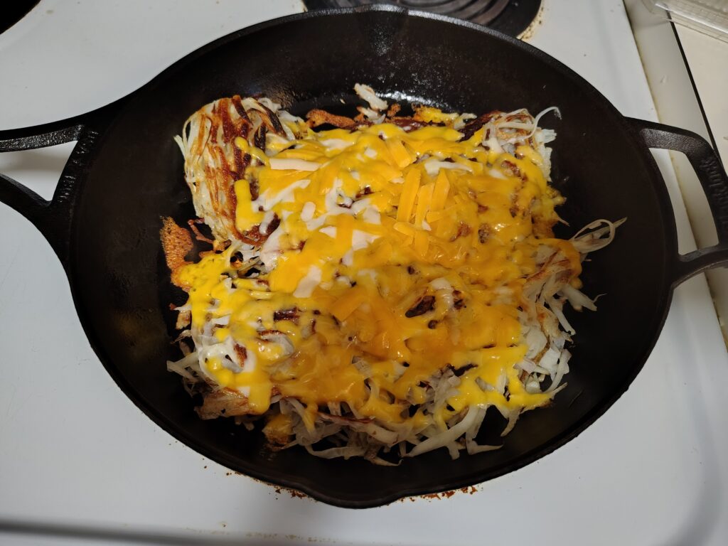 Hash browned potatoes with melted cheese on top.