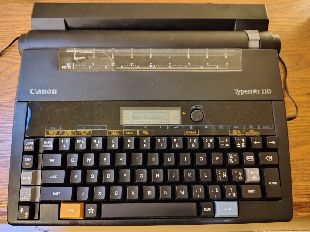 odd typewriter word processor hybrid manufactured by Canon in the early 1980s. It has a lcd display where someone has typed "word processor."